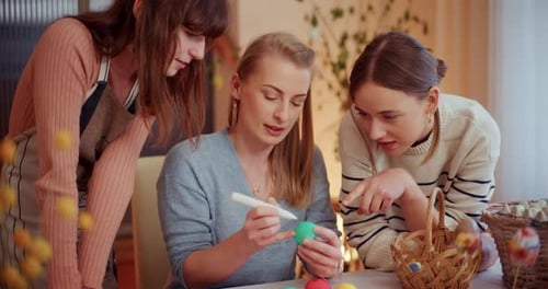 Sisters Painting Easter Eggs for Easter Holidays