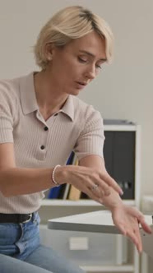 Vertical of Female Patient Showing Allergy Spots during Dermatology Consultation