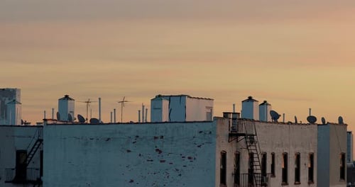 Quiet static shot of Brooklyn rooftop at sunset with beautiful colorful sky behind it 4K CINEMATIC