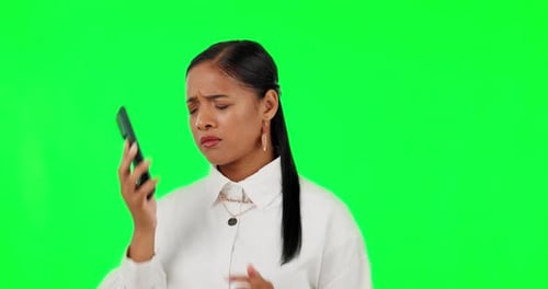 Phone call, bad news and anger with a woman on a green screen background in studio looking upset