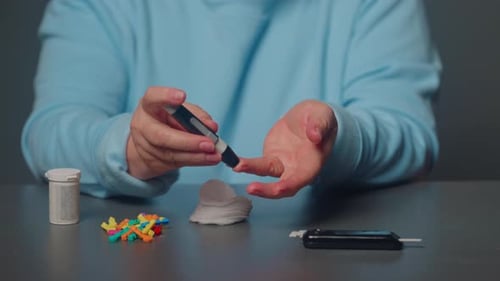 Diabetic Aged Woman Patient Suffering Sugar Diabetes Measures Blood Glucose Level with a Glucometer