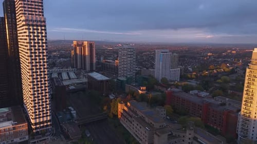 Illuminated sunlit Croydon high rise towers aerial view across London city residential apartments