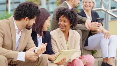 Business Multiethnic People Financial Business People Discussing and Smiling Looking at Tablet