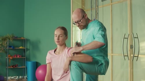 The Personal Trainer Gives the Athlete a Massage to Restore Physical Functions