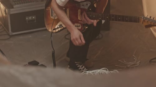 Guitarist Plugging Electric Guitar into Modular Synthesizer