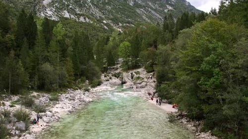 Aerial view of serene river valley at sunrise in Julian Alps, Soca, Slovenia.