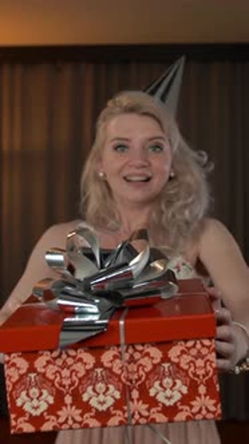 Vertical of Female Hands Giving White Present with Silver Bow