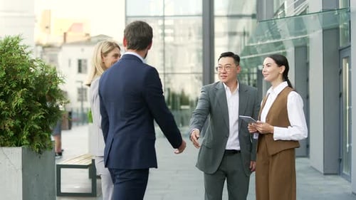 B2B Business welcome meeting group with staff and partnership outside office diverse team. Shaking