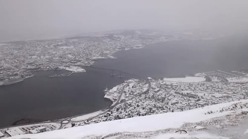 Wide View of the City of Tromso, Norway During a Snowstorm