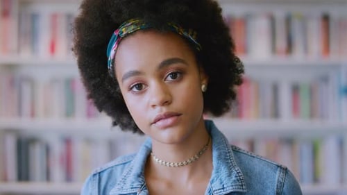 Black woman, face or afro in school library, college or university and education goals