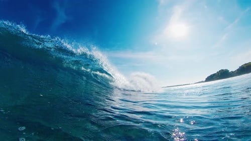 Crystal clear wave breaks in the ocean on the Maldivian shore