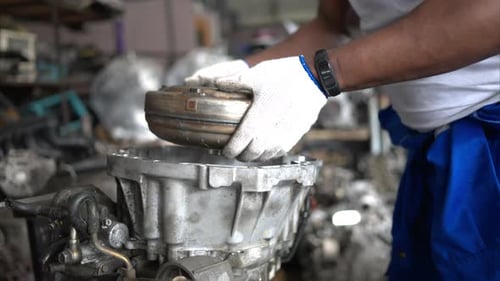 Men repairing car engine in auto repair shop, Selective focus.