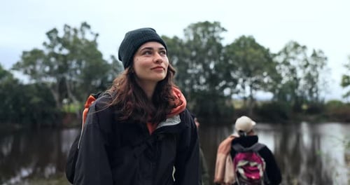 Woman, hiking and friends at a lake in nature for view or peace on a journey