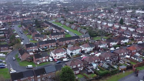 Aerial view above North England terraced residential town neighbourhood property panning right looki