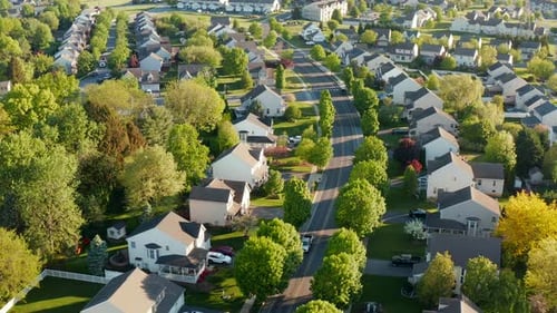 Truck drives through suburban residential housing development. Aerial of modern home community in Un