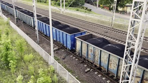Cargo Train in Motion Loaded with Black Coal Top View From Above Railway Cargo Cars Freight Train