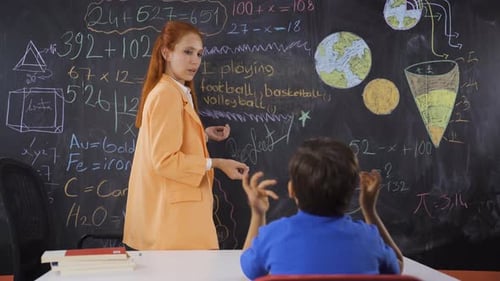 Teacher teaching punctuation to her boy student.