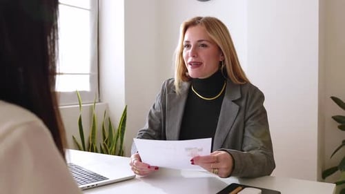 Mature Woman Giving Resume to Young Female HR Manager While Having Job Interview