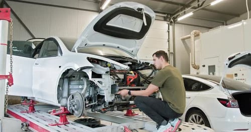 Mechanic Repairing Car In Modern Auto Workshop