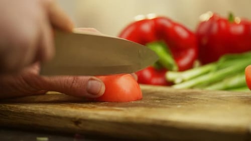 Cutting a Red Ripe Tomato with a Poorly Sharpened Knife