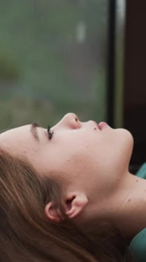 Businesswoman Looks at Window During Rain