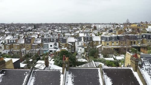 Aerial drone view over houses in neighborhood Clapham after snowfall, London