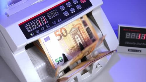 Financial money currency counting machine. Close up of euro banknotes while counting.