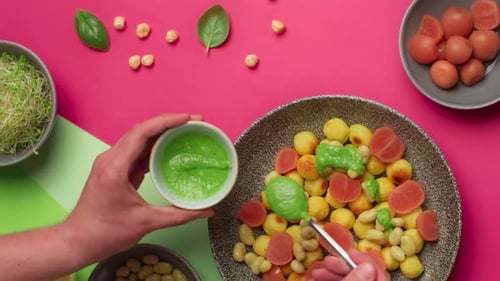 Tabletop Food Video Recipes Man Adds Pesto Sauce to the Fried Potato Dumplings
