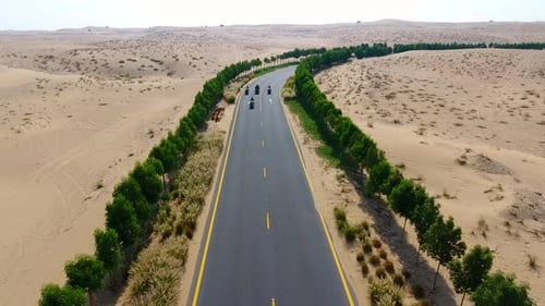 Aerial shot of Bikers on a desert road in Dubai