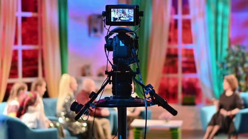 Professional television camera shooting a talk show in a studio. Video production backstage