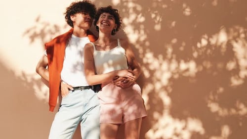 Young man and woman posing in the street