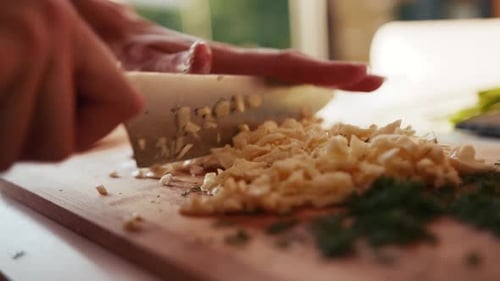 Extreme Close Up View of Female Hand Chopping Mushrooms Cheese on a Wooden Chopping Board Cooking