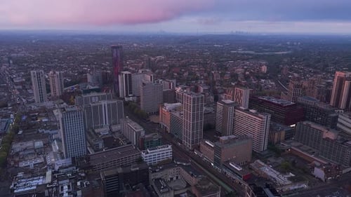 Aerial view looking down over Croydon high rise city centre and city streets under sunset cloudy sky