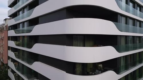 Aerial View of a Drone Flying Around and Along the Facade of a Modern Residential Building