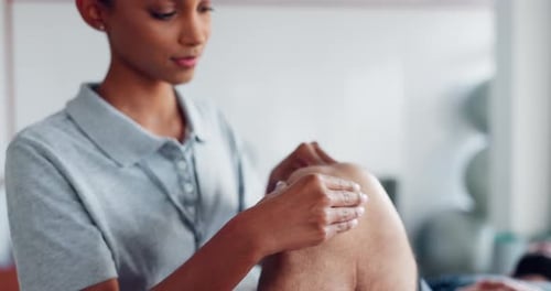 Knee injury, massage or physiotherapist in physiotherapy to relax the body or legs for healing pain