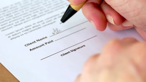 Closeup Shot of Young Woman with Pen Signing Contract