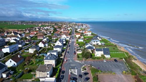 Coastal road of Saint-Aubin-sur-Mer, Normandy, France. Aerial forward