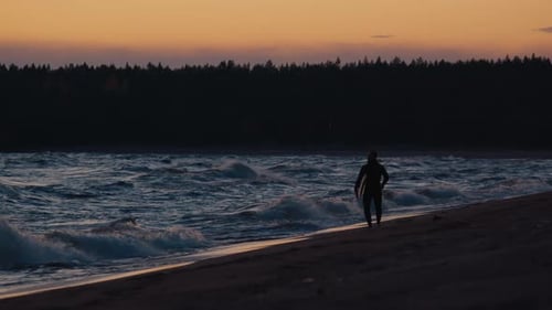 Ladoga lake surfing. Man in black wetsuit surfs the wave on Ladoga Lake during windy sunny day