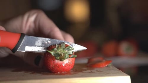 Cutting And Slicing Strawberry Using A Knife. - close up shot