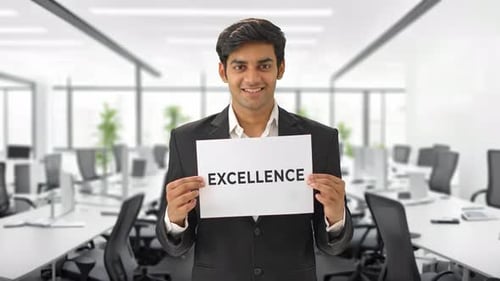 Happy Indian manager holding EXCELLENCE banner