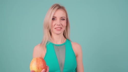 A Woman in a Colorful Outfit Holds a Fresh Apple Symbolizing a Healthy Balanced Lifestyle