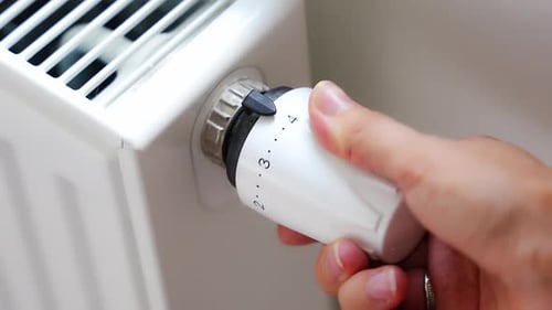 A Woman's Hand Turns the Battery Heating Knob Heating in an Apartment at Home Heating Prices