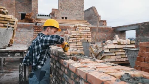 Construction worker in uniform and safety equipment have job on building