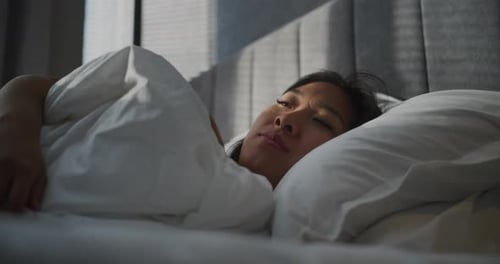 Young Girl Wakes Up Early in Morning in Bedroom