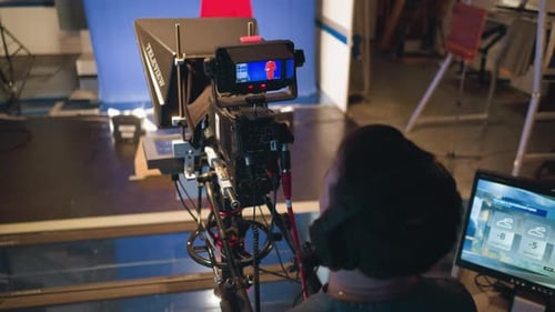 Cameraman Filming Presenter with Teleprompter in Studio During Weather Broadcast