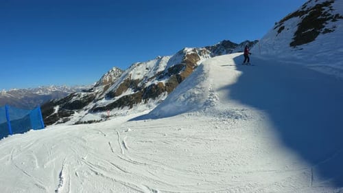 Skier Reaching The End Of A Downhill Ski Trail
