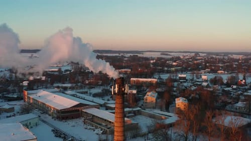 Aerial view of chimney tower in city release dense smoke in atmosphere