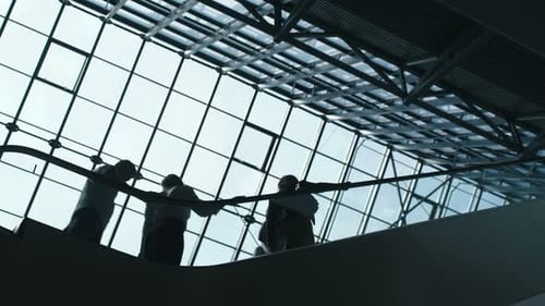 Escalator carries people inside a modern corporate building with glass walls
