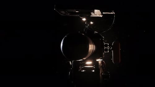 Professional Video Camera Illumined in Dramatic Spotlight