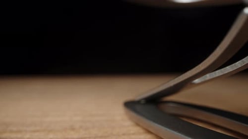 fingernail clipper on a black background. Dolly slider, extreme close-up.